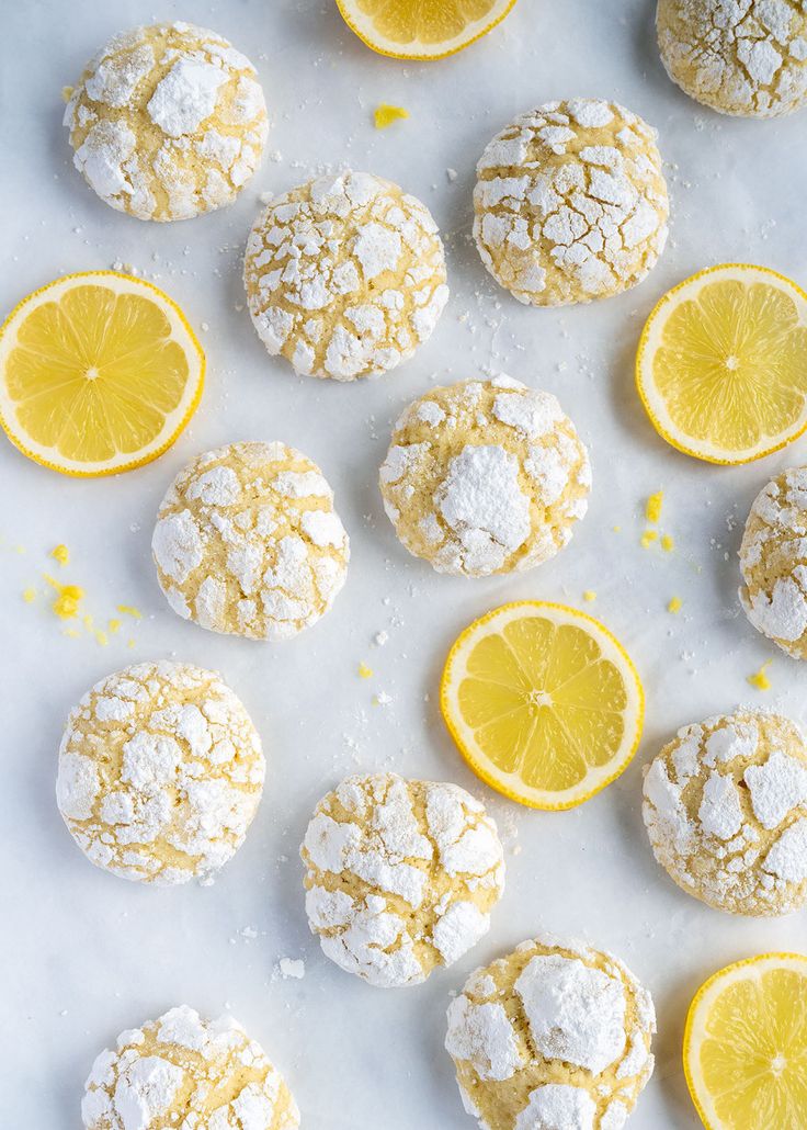 lemon and powdered sugar cookies on a white surface