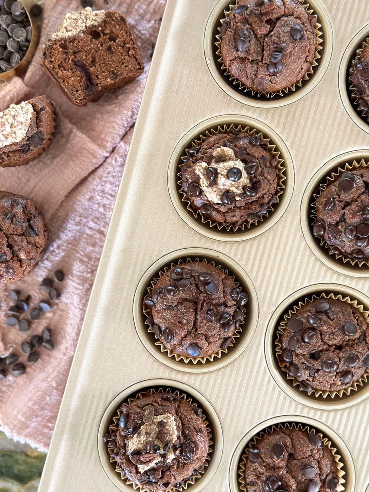 chocolate cupcakes in a muffin tin on a table