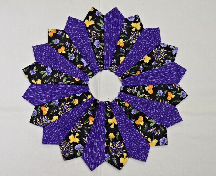 a purple and black flower with yellow flowers on it