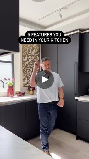 a man walking through a kitchen with the words 5 features you need in your kitchen