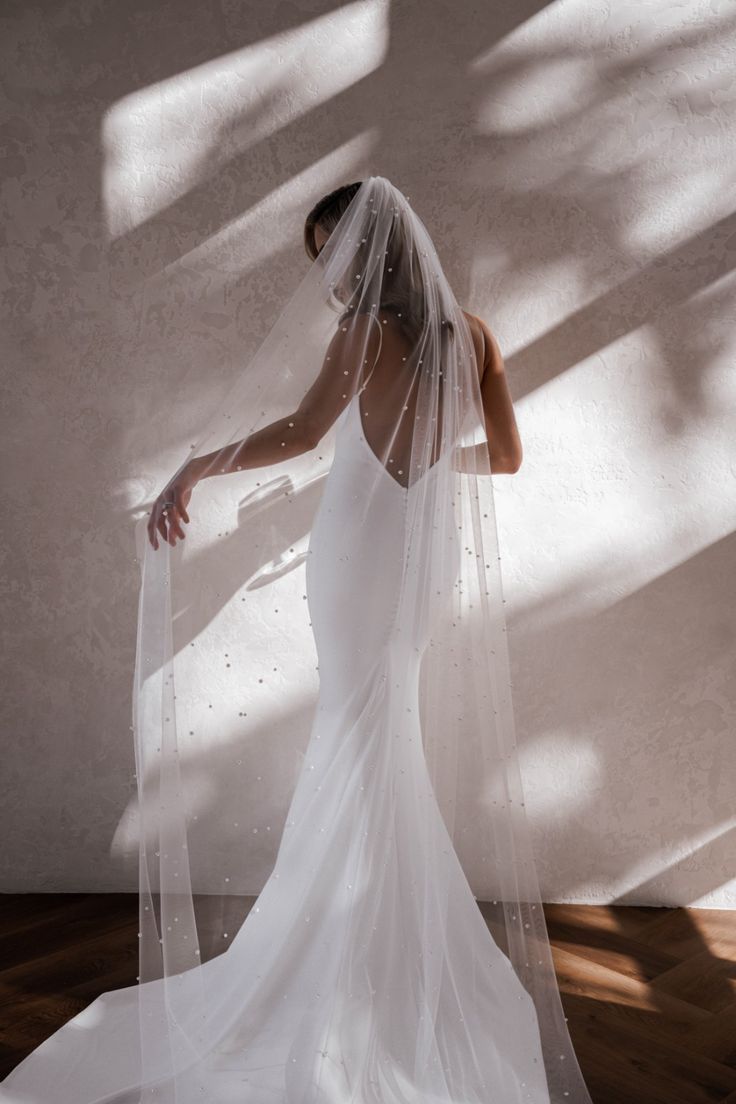 a woman in a white wedding dress and veil