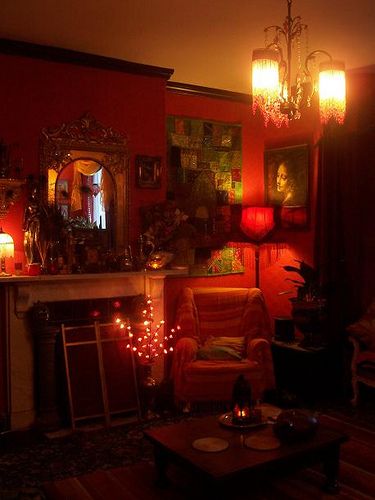 a living room filled with furniture and a fire place next to a fireplace covered in candles