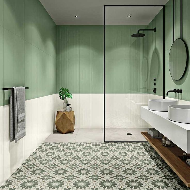 a green and white bathroom with two sinks