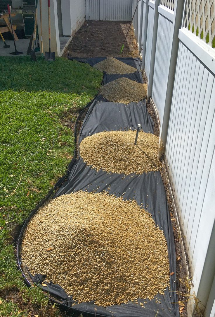 a fence with some grass and dirt in it