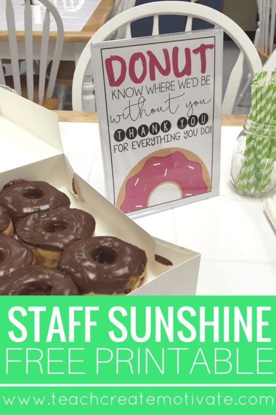 a box of doughnuts sitting on top of a table next to a donut sign