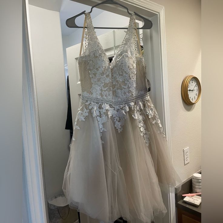 two dresses hanging on a rack in front of a mirror