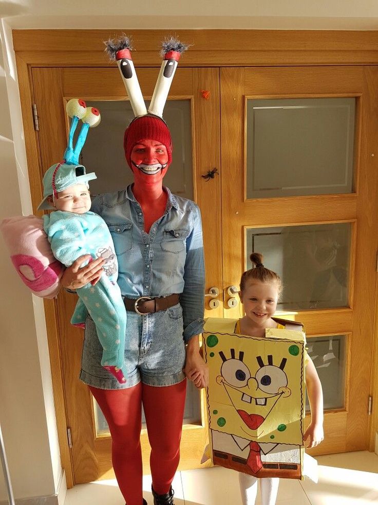 a woman and two children are dressed up in costumes