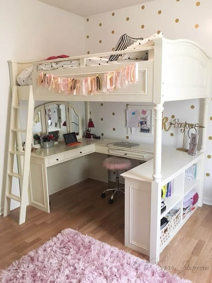 a white bunk bed sitting next to a pink rug on top of a hard wood floor