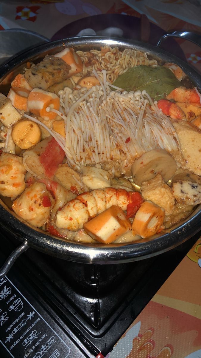 a pan filled with food sitting on top of a stove