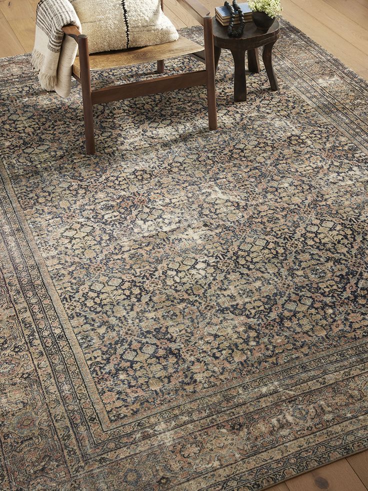 a living room with a large rug on the floor