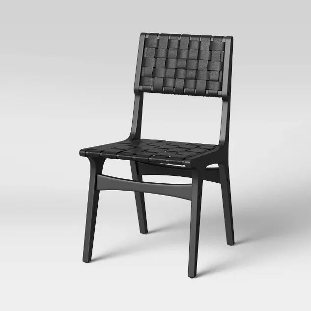 a black chair sitting on top of a white floor