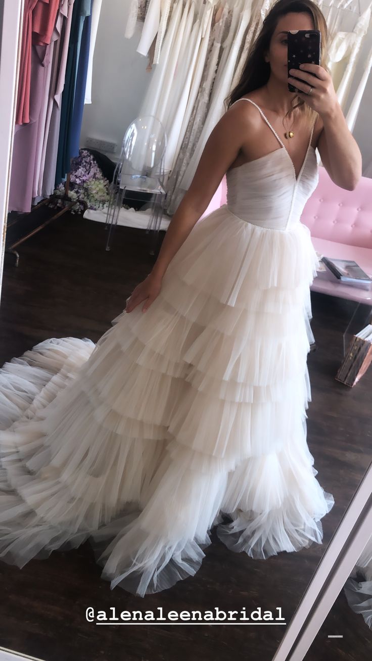 a woman taking a selfie in her wedding dress