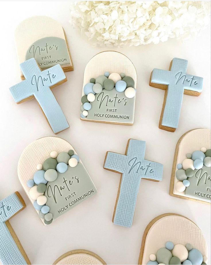 cookies decorated with pastel blue and white candy are arranged on top of a table