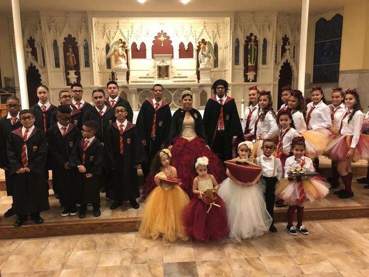 a group of children and adults posing for a photo in front of a church alter