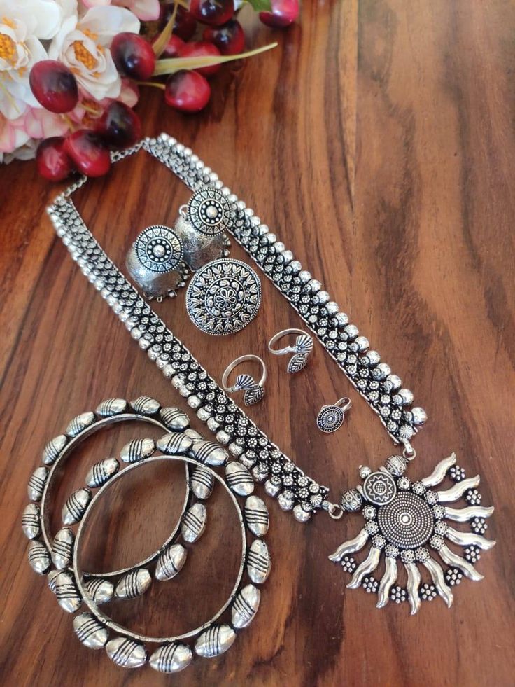 This beautiful set of 6 has a big long oxidized Haram necklace with a pair of jhumka earrings, a ring,pair of bangles, a pair of leg ring and a nose pin. Grab this beautiful set with any of the ethnic/ Indo western outfit and look unique in the crowd Premium quality set!! Oxidized Finish Chandbali Jewelry Sets, Oxidized Chandbali Jewelry Sets, Black Jewelry Set, Maharashtrian Jewellery, Silver Anklets Designs, Oxidised Silver Jewelry, Anklet Designs, Silver Necklace Set, Silver Jewellery Indian