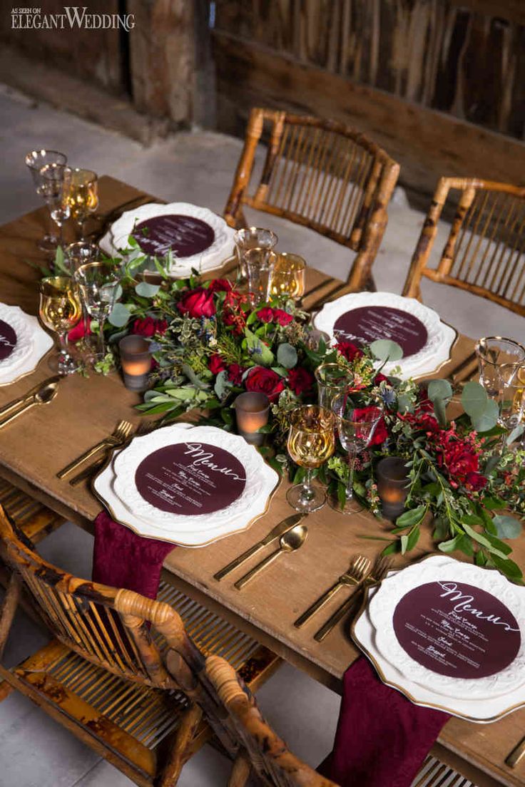 the table is set with plates and place settings for guests to sit down at it