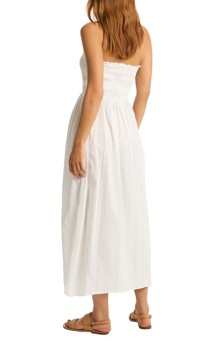 This strapless cover-up dress is crafted of from cotton and designed with a smocked bodice that leads to a flowy skirt. 44" center front length (size Medium) Slips on over head Strapless Smocked bodice 100% cotton Hand wash, dry flat Imported Strapless Smocked Bodice Sundress For Beach, Strapless Sundress With Smocked Bodice For Beach, Strapless Sundress With Smocked Bodice For Vacation, Strapless Vacation Dress With Smocked Back, Strapless Dresses With Smocked Back For Vacation, Casual Bandeau Dress With Smocked Bodice, Casual Bandeau Dress With Smocked Back, Beach Strapless Dress With Smocked Bodice, Strapless Ruched Sundress For Beach