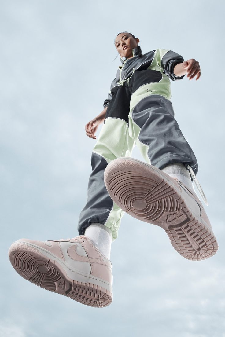 a man is jumping in the air with his shoes on and one foot up above him