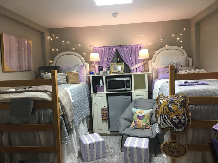 a bedroom with bunk beds, desk and chair in it's center area that has purple curtains on the windows