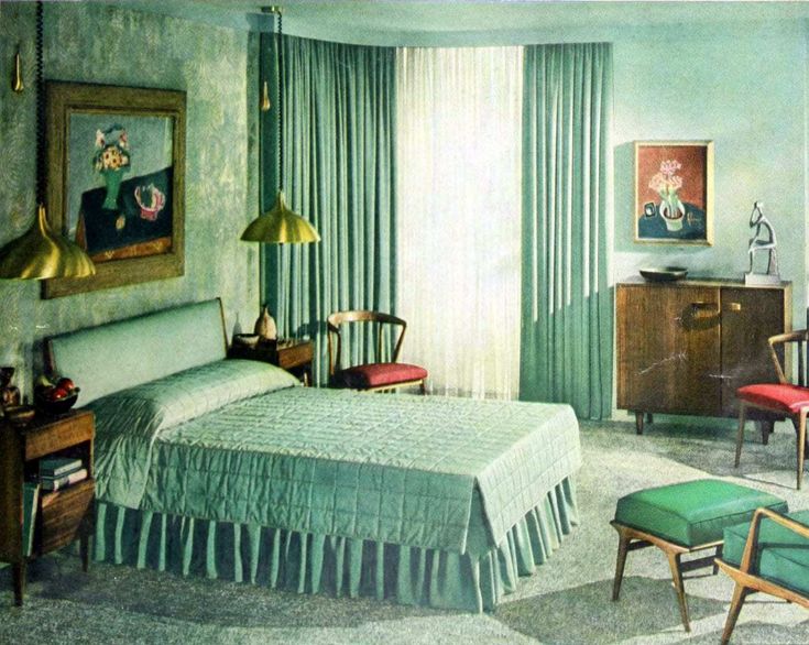 the bedroom is decorated in green and blue tones, with an old fashioned chair at the foot of the bed