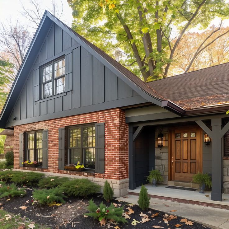 a brick house with green shutters and brown doors