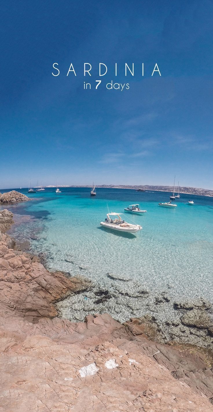 there are boats that are floating in the clear blue water on this beach, and it is time lapse