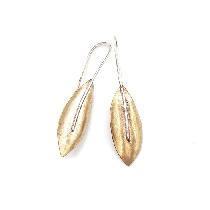 Adorn your ears with a fallen leaf in these gorgeous handcrafted brass leaf earrings. NuGold (brass) Argentium Silver Measures: 1.75 L x .5″ W Each piece is one-of-a-kind and handcrafted ... Elegant Gold Hoop Earrings With Oxidized Finish, Gold Leaf-shaped Brass Jewelry, Leaf-shaped Yellow Gold Brass Jewelry, Gold Fusion Drop Earrings, Unique Gold Teardrop Earrings Nickel Free, Gold Fusion Style Drop Earrings, Leaf-shaped Brass Earrings For Gift, Leaf-shaped Brass Earrings As Gift, Gold Fusion Earrings With Oxidized Finish