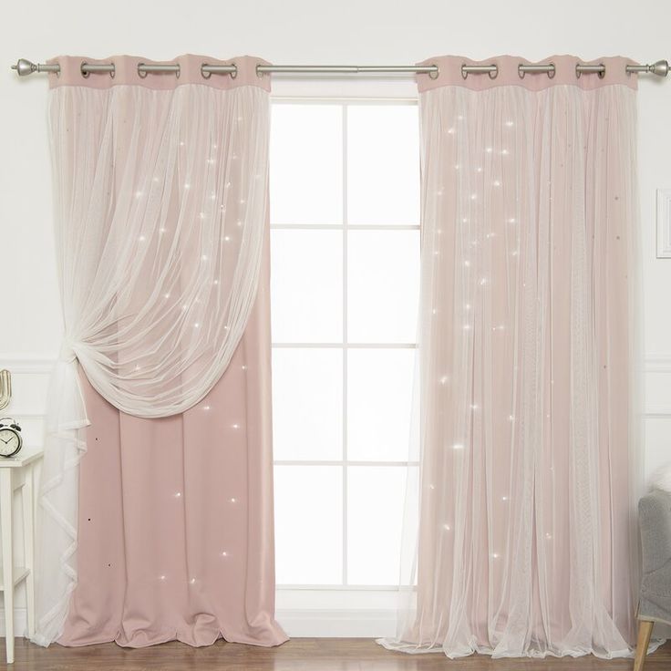 the curtains in this room are pink with white stars on them and sheer drapes