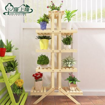 there is a wooden plant stand with plants on it