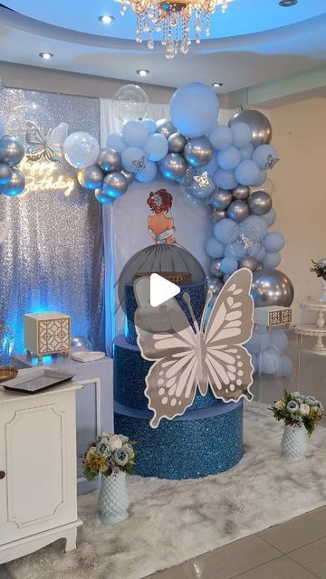 a room filled with balloons and decorations on the floor, including a butterfly decoration centerpiece