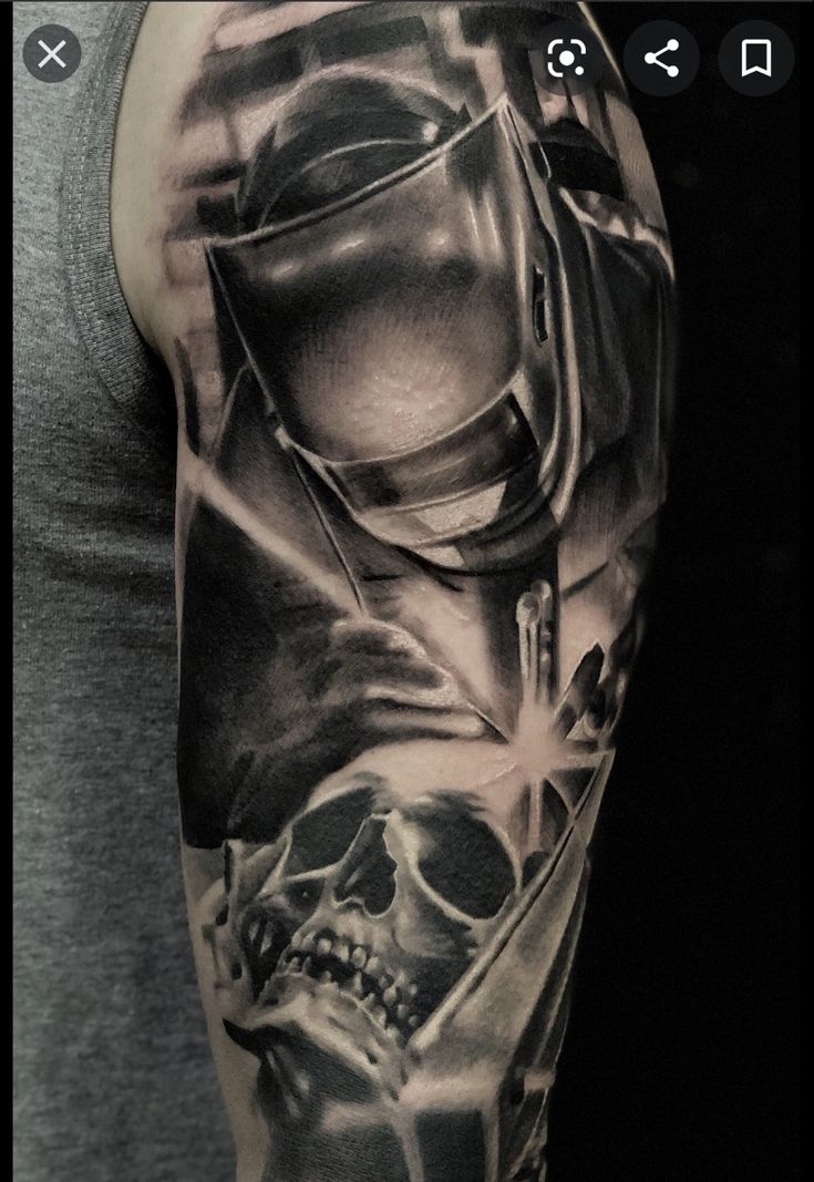 a man's arm with a black and grey tattoo on it that has a skull in the middle