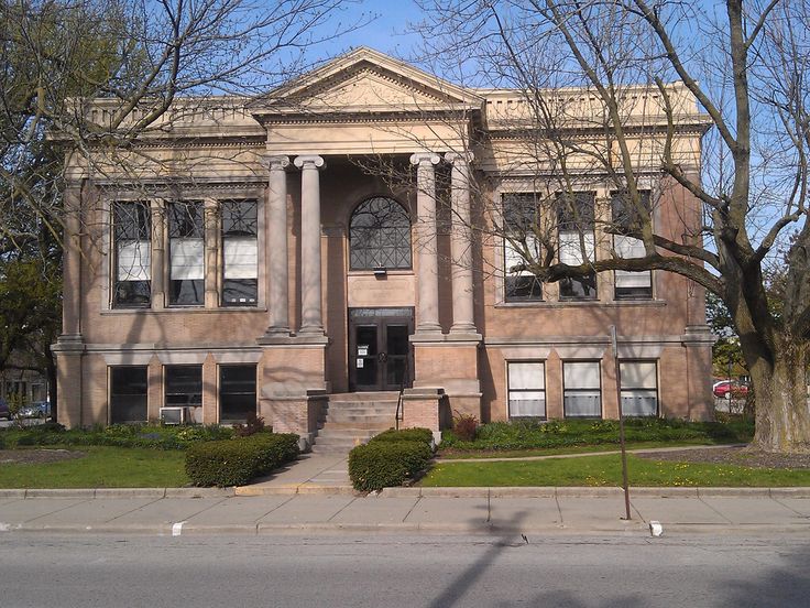 an old building with columns and pillars on the front