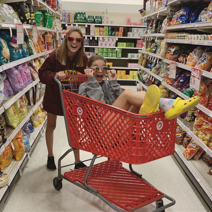 a woman and child sitting in a shopping cart