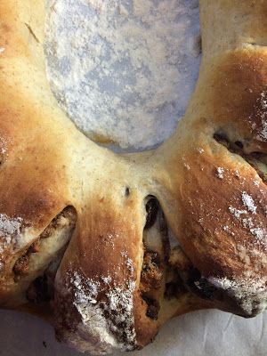 a loaf of bread sitting on top of a white table cloth covered in powdered sugar