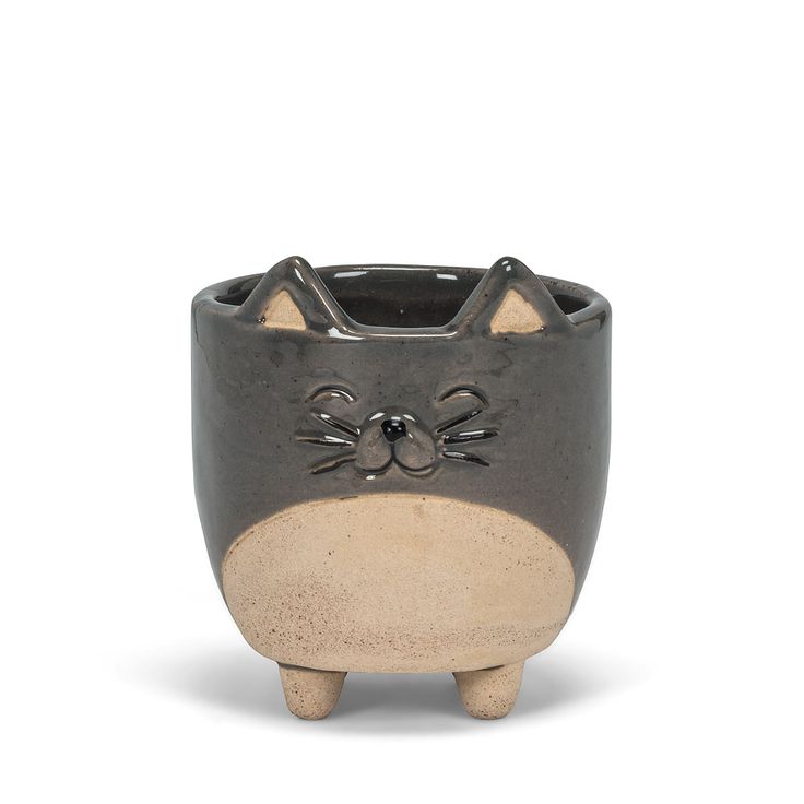 a ceramic cat planter sitting on top of a white table