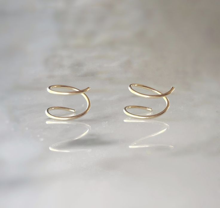 These 14k gold fill spiral earrings are the epitome of simplicity and style, perfect for your everyday look. With their minimalist design, they effortlessly enhance your style, allowing you to make a statement that reflects your unique personality. Embrace the trendy and fun vibes with these captivating spiral earrings, as they effortlessly add a touch of confidence and flair to your daily adventures. These measure 8mm. Gold Minimalist Spiral Wrap Earrings, Minimalist Gold Spiral Wrap Earrings, Gold Spiral Minimalist Earrings, Minimalist Gold Spiral Earrings, Minimalist Swirl Earrings As Gift, Minimalist Swirl Earrings Gift, Minimalist Spiral Earrings For Everyday Wear, Minimalist Spiral Everyday Earrings, Minimalist Everyday Spiral Earrings