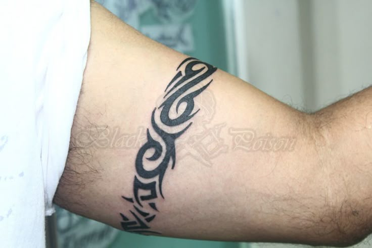 a man's arm with a tattoo on it and the word moto written in cursive writing