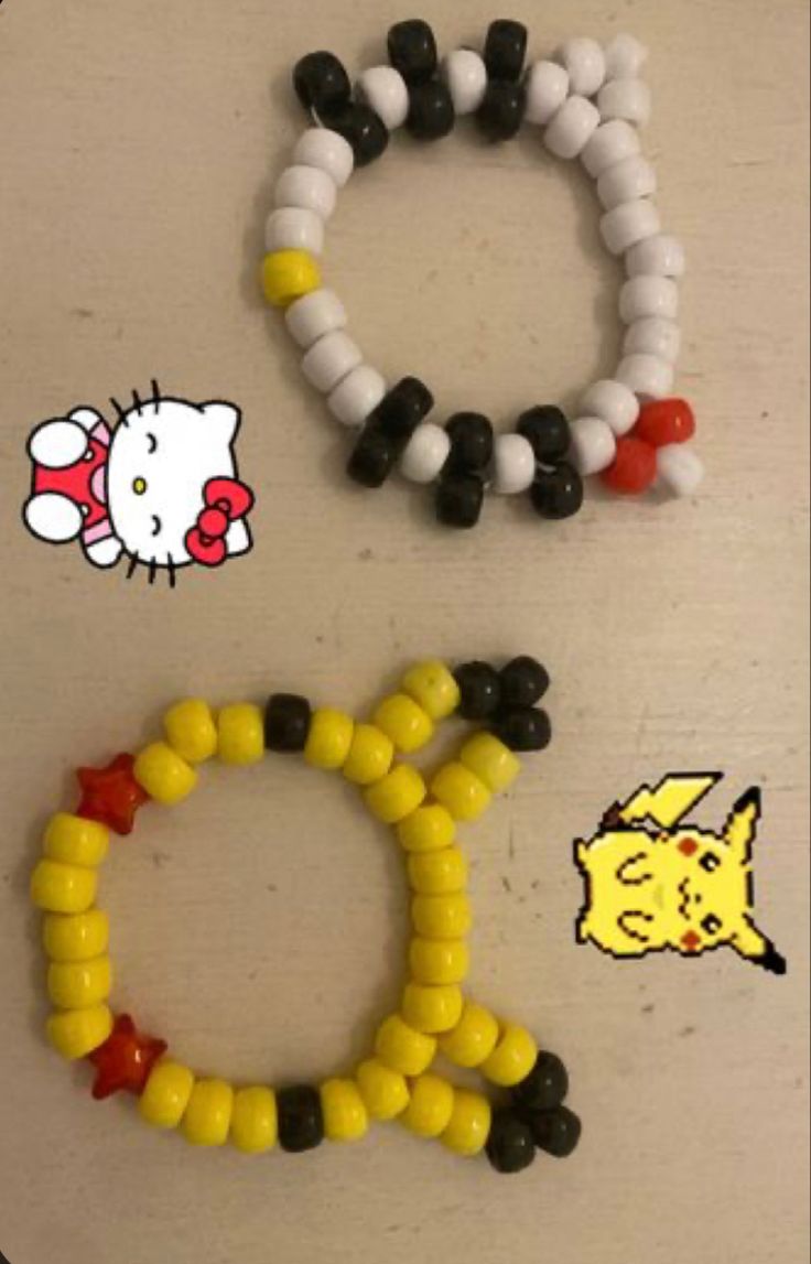 three different bracelets made out of candy corn and black, white, and yellow beads