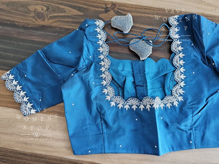 Blouse stitched - Yes Blouse Opening - Front Sleeves Length - Elbow Padded - No Blouse size - 36 with inner margins expandable upto 42 For Blouse Size 34 alteration can be done on request. Elegant Cotton Blouse With Cutdana Detailing, Fitted Cotton Blouse With Lace Work, Fitted Lace Work Cotton Blouse, Fitted Blue Tops With Cutdana, Traditional Fitted Lace Work Blouse, Blue Cotton Blouse For Wedding, Maggam Blouse, Ethnic Sarees, Elbow Pads