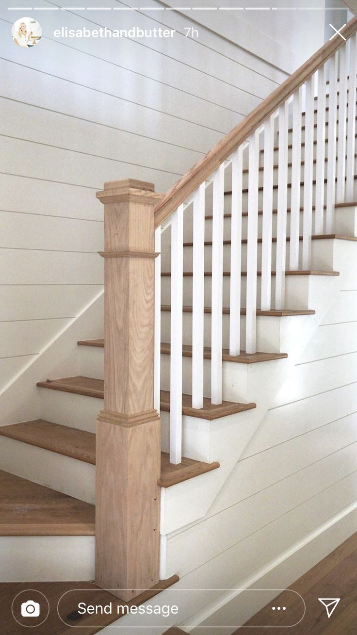 the stairs in this house are white and have wood balusters on each handrail