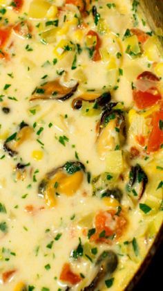 an omelet with vegetables and cheese in a pan