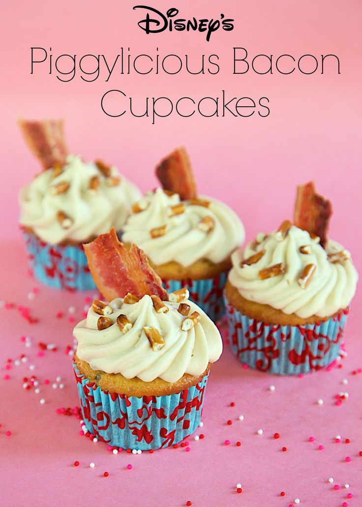 cupcakes with bacon on top and frosting in the middle are sitting on a pink surface