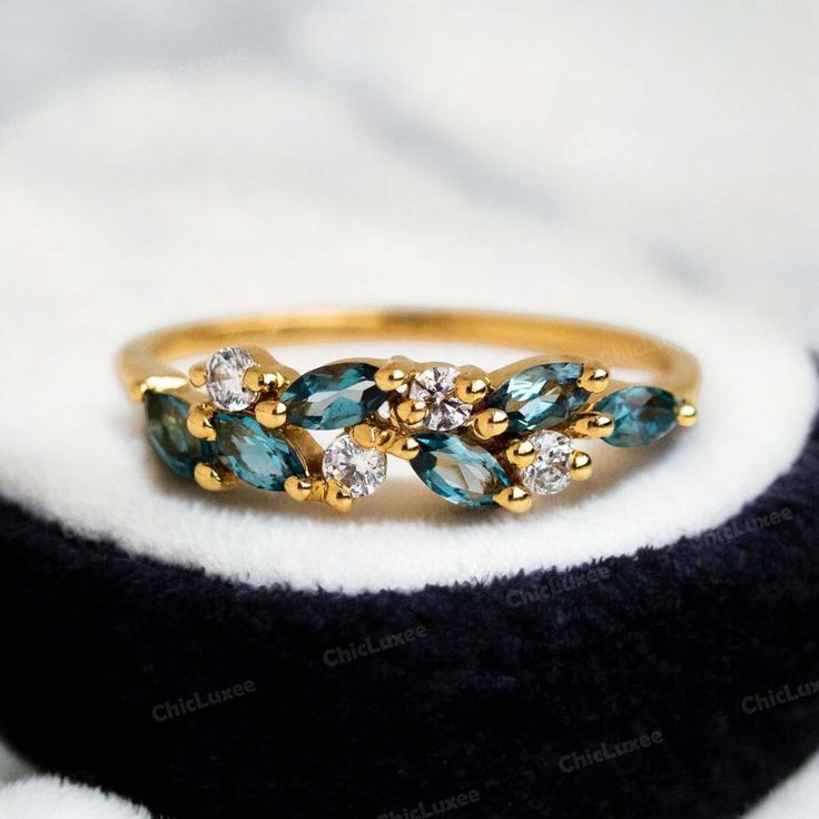 Leaf Design 14k Gold Marquise Cut London Blue Topaz Weeding Band, Dainty Stackable Ring For Women, November Birthstone Anniversary Gift  * Gemstone - London Blue Topaz ( Lab Created ) * Gemstone Shape - Marquise * Gemstone Size - 4x2 mm  Gemstone Color : Blue Secondary Stone : CZ Diamond Stone Color : Colorless Stone Shape : Round /  *Custom Order Accepted As Per Your Requirements *PAYMENT INFORMATION - Payment in full by PAYPAL *SHIPPING We use 2 modes of shipment: - (01) STANDARD SHIPPING - It takes 12 to 18 Working days delivery time BY INDIAN FREE SHIPPING !! (02) EXPRESS SHIPPING - It takes 5 to 7 Working days delivery time by UPS, DHL & Aramax at $45 per parcel !! *Feedback :- Please Give us a Positive Feedback, your feedback is very important for us and In any case of any problem co Turquoise Cubic Zirconia Jewelry For Anniversary, Anniversary Turquoise Cubic Zirconia Jewelry, Sapphire Topaz Ring In 14k Gold For Wedding, Wedding Sapphire Topaz Ring In 14k Gold, Sapphire Cluster Ring With 17 Jewels For Wedding, Fine Jewelry Cluster Topaz Wedding Ring, Turquoise Topaz Wedding Ring In Fine Jewelry Style, Turquoise Topaz Wedding Ring Fine Jewelry, Blue Topaz Marquise Cut Wedding Jewelry