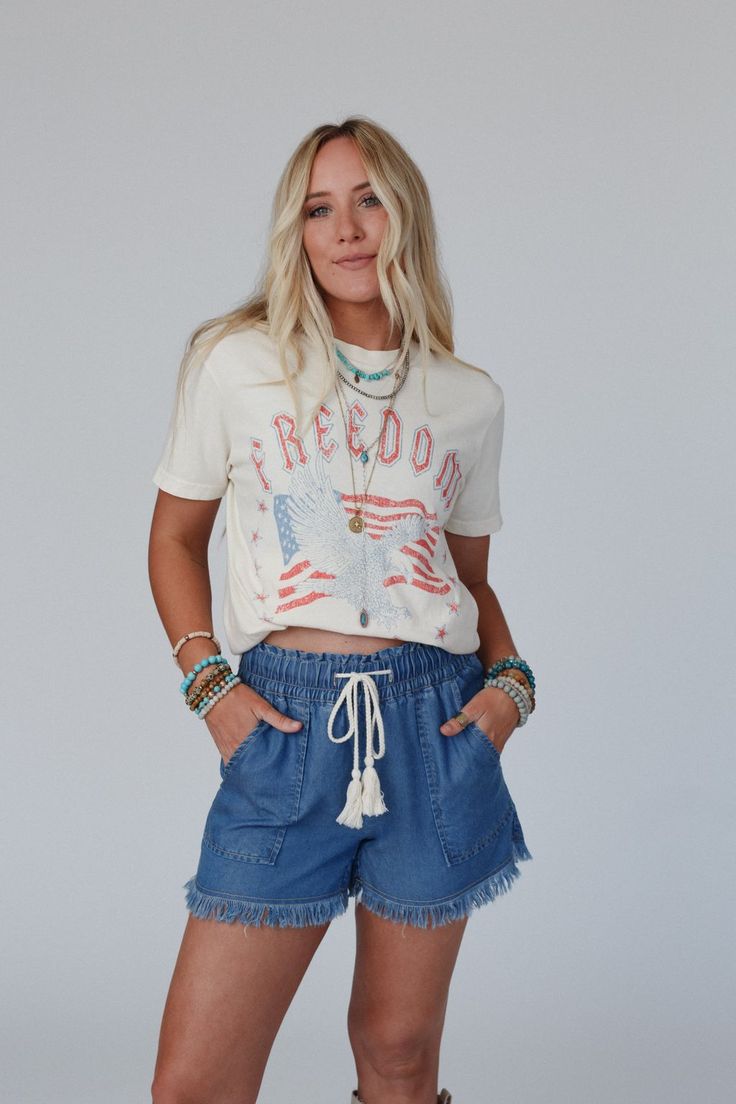 Everyone needs their go - to graphic tee and the Freedom Eagle Graphic Tee is the perfect essential to your boho closet! Comfortable, mineral - washed, Cotton tee shirt fabric Relaxed and loose tee shirt silhouette Classic crew neckline and loose short sleeves So CUTE Distressed Eagle with American Flag and 'Freedom 1776' graphic Pair with: Dora Low Back Seamless Bralette, Straight Arrow Jeans, and Sparrows Song Necklace *Due to lighting and differences in monitors, actual colors may vary slight Trendy Frayed Hem Summer T-shirt, Casual Summer T-shirt With Frayed Hem, Spring Crew Neck Stonewashed T-shirt, Trendy Stonewashed T-shirt For Spring, Trendy Stonewashed T-shirt For Summer, Bohemian Crew Neck Washed Tops, Bohemian Washed Crew Neck Tops, Bohemian Acid Wash Crew Neck Top, Casual Frayed Hem T-shirt For Summer