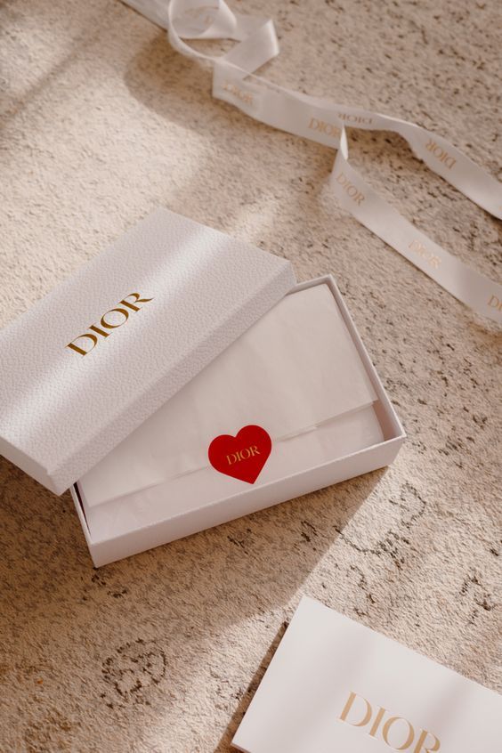 a white box with a red heart on it next to a note that says i love you