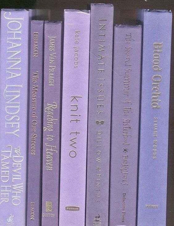 a row of purple books sitting on top of each other