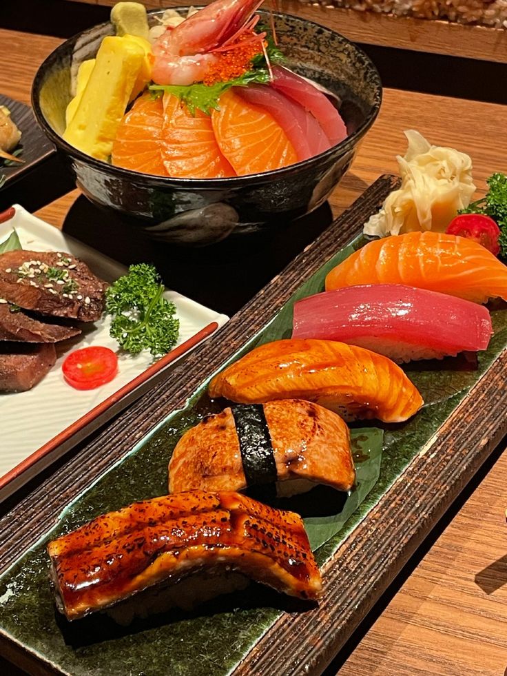 there are many different types of sushi on the table, including salmon and shrimp