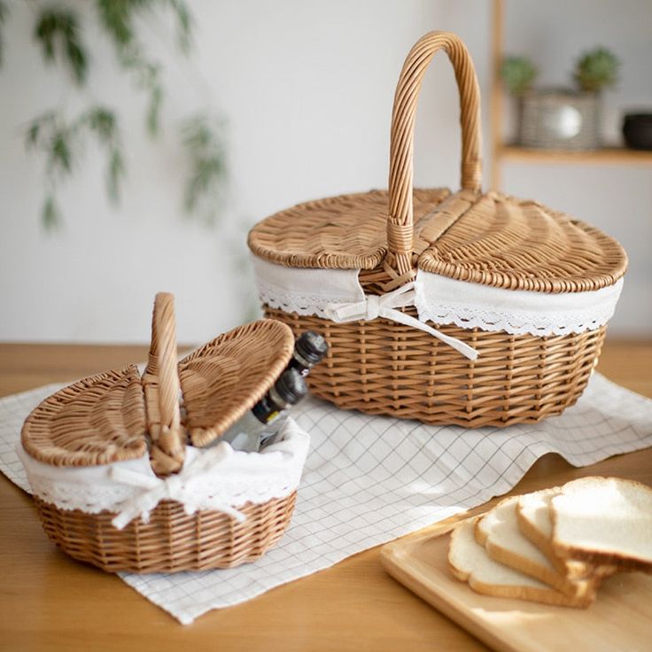 two wicker baskets sitting on top of a wooden table next to slices of bread