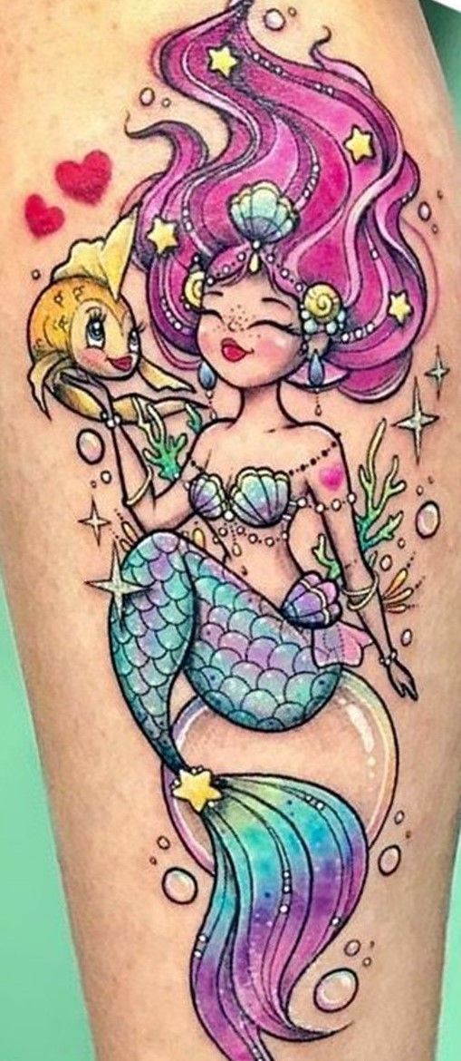 a girl with pink hair and a mermaid tattoo on her thigh