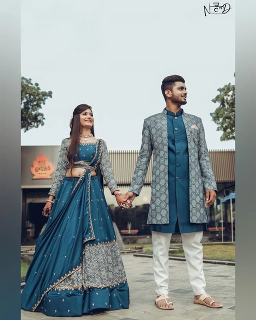 a man and woman holding hands while standing next to each other